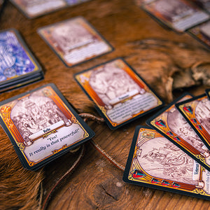 Collection of fantasy trading cards on a wooden surface