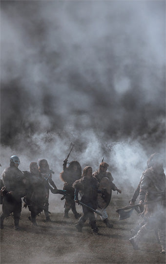 Players in a Larp battle scene with smoke and dust
