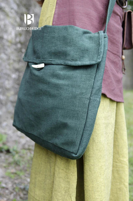 Green shoulder bag worn by a person with a blurred natural background