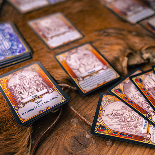 Collection of fantasy trading cards on a wooden surface