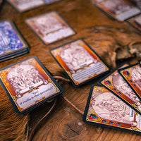 Collection of fantasy trading cards on a wooden surface