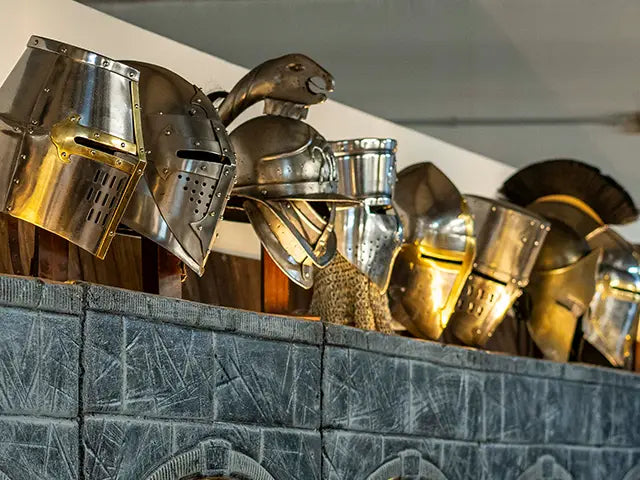 medieval helmets on a tiled wall