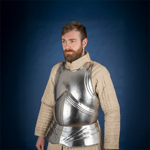 Man wearing a silver breastplate against a blue background