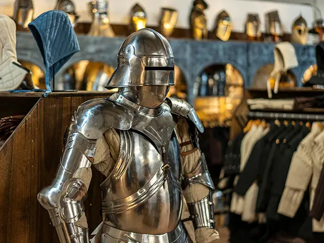 full metallic armor in a store setting with clothing racks and shelves in the background.